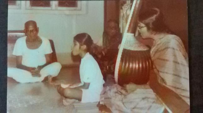 Little Nanditha singing, with grandmother Smt Thulasi Ammal on the violin and mother Smt Ravi Ravi on the tambura. Grandfather Shri M.R. Subramaniam listens in rapt attention.